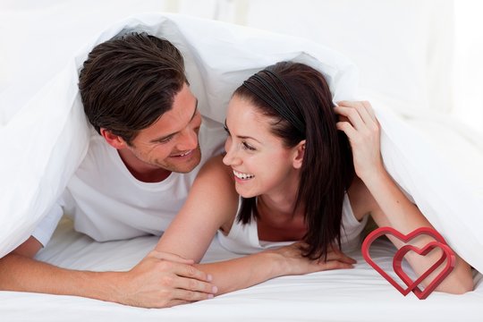 Composite image of couple talking together and lying on bed