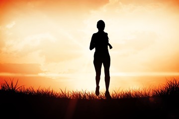 Composite image of focused fit blonde jogging