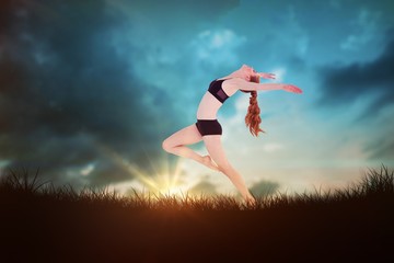 Composite image of side view of a sporty young woman stretching