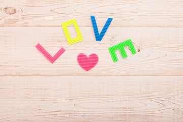 Word love on wooden background. Valentines day