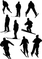 nine black skier silhouettes isolated on white