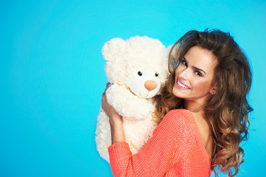 Portrait of beautiful pretty woman with teddy bear