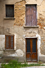 Fototapeta na wymiar brown door europe in the milano window closed brick grass