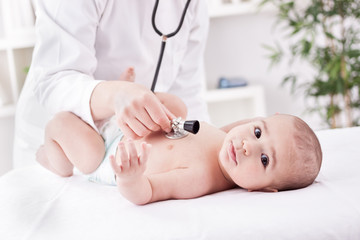 Female doctor listens to the heart with stethoscope