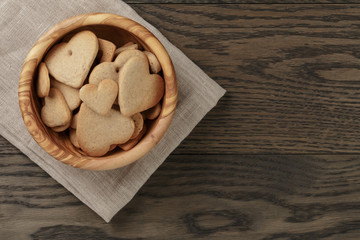 heart cookies for valentines day in olive bowl on wood table