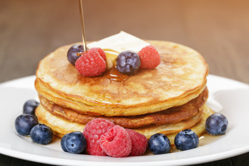 Classic pancakes with butter berrys and maple syrup