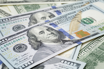 new hundred dollar notes on heap of old notes