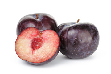 three ripe black plums isolated