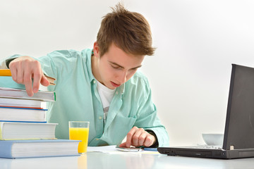 Young man working on laptop in office.