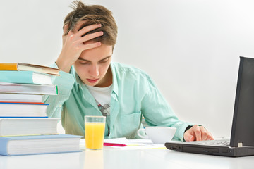 Young man working on laptop in office.