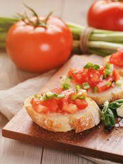 Fototapeta na wymiar simple italian appetizing bruschetta with tomato and basil, on
