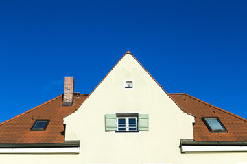 family home in suburban area with blue sky.