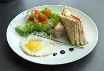 classical breakfast with fried eggs and sandwiches