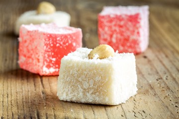 Red  and white Turkish Delight with coconut in a wooden bowl 