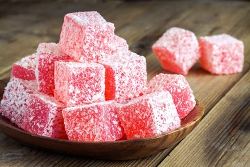 Red  and white Turkish Delight with coconut in a wooden bowl 