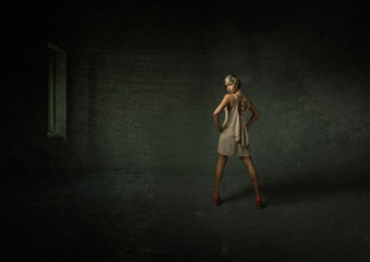 nice blonde woman posing in a dark room