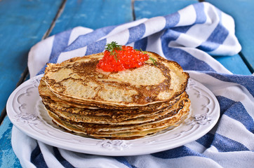 A stack of pancakes with red caviar