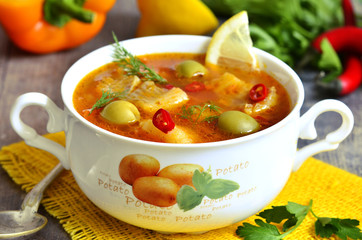 Fish solyanka - traditional russian soup with pickles.