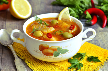 Fish solyanka - traditional russian soup with pickles.