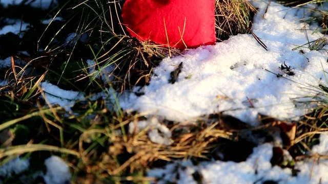 textile red heart on snowy winter ground