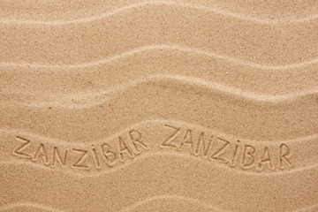 Fototapeta na wymiar Zanzibar inscription on the wavy sand