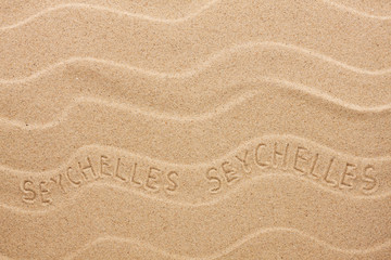 Fototapeta na wymiar Seychelles inscription on the wavy sand
