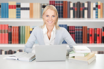 Young College Student Girl In A Library