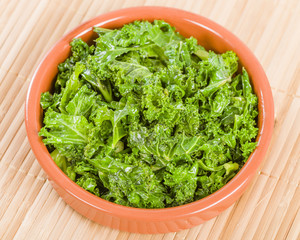 Curly Kale - Cooked cale in an earthenware dish.
