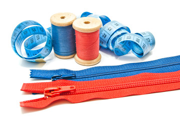 two zipper, meter and two spools of thread
