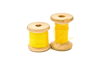 spools of yellow thread on white