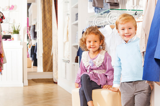 Smiling boy and girl are together while shopping