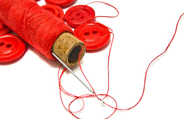spool of thread and red buttons
