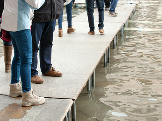 Fototapeta premium People walking on catwalk in Venice