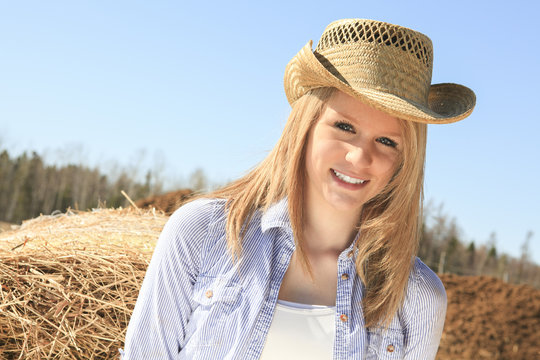 Young american cowgirl woman portrait outdoors.