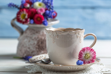 Closeup of daisy flowers and cup of coffee