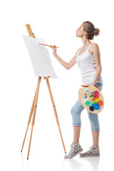 Girl paints on canvas with oil colors.