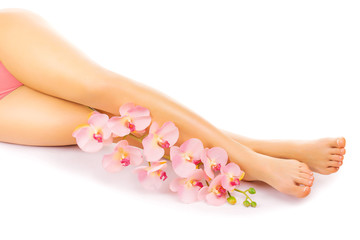 Relaxing pedicure with a pink orchid flower