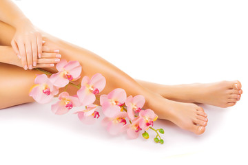Relaxing manicure and pedicure with a pink orchid flower - obrazy, fototapety, plakaty