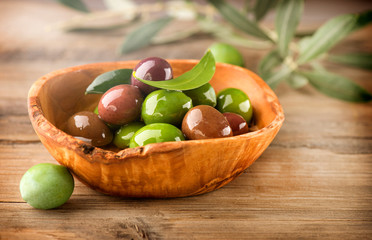 Olives and Olive Oil on the wooden table