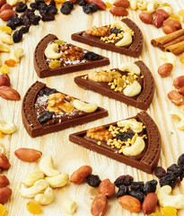 Dessert chocolate pizza with raisins and nuts