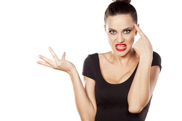 Fototapeta premium angry woman with a questionable gesture and finger on forehead