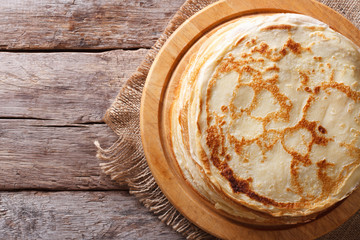 fried crepes on a chopping board horizontal top view - obrazy, fototapety, plakaty
