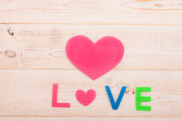 Word love on wooden background. Valentines day