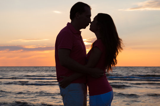 Couple About To Kiss At Beach During Sunset