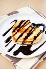 Loving heart shaped pancakes with chocolate sauce