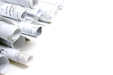 Architectural blueprints and blueprint rolls with magnifying gla