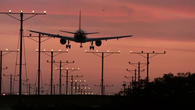 airplane landing at sunset on runway in LAX airport in Los Angeles LA in 4K and 1080 HD with sound