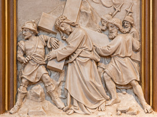 Fototapeta na wymiar Vienna - Simon of Cyrene help Jesus to carry his cross.