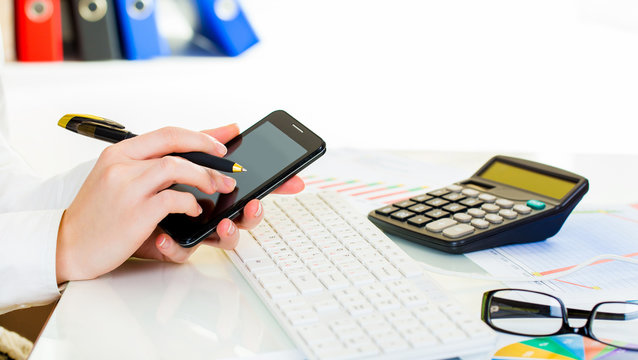 business woman take gadget phone in office