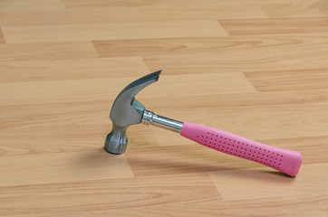 pink hammer on a wooden floor